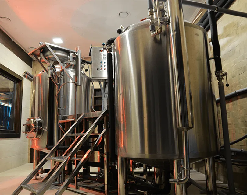 The stainless steel tanks of the Predná Hora brewery in dim red light